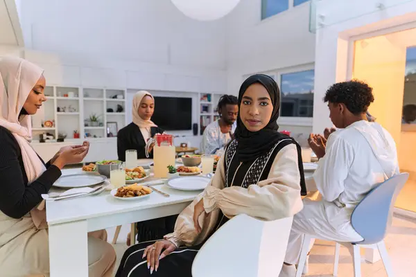 In the sacred month of Ramadan, a diverse Muslim family comes together in spiritual unity, fervently praying to God before breaking their fast, capturing a moment of collective devotion, cultural