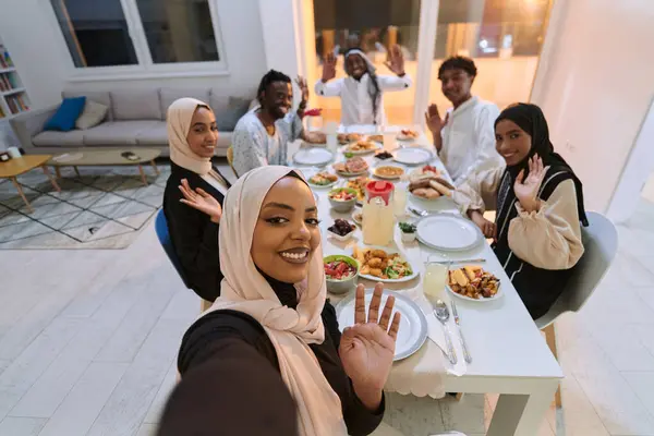 A traditional Muslim family captures the joy of their shared iftar meal during the sacred month of Ramadan through a cheerful family selfie, blending cultural richness, familial togetherness, and the
