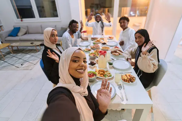 A traditional Muslim family captures the joy of their shared iftar meal during the sacred month of Ramadan through a cheerful family selfie, blending cultural richness, familial togetherness, and the