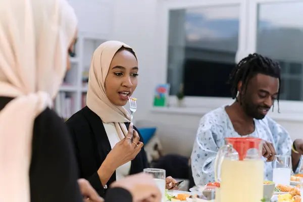 A traditional and diverse Muslim family comes together to share a delicious iftar meal during the sacred month of Ramadan, embodying the essence of familial joy, cultural richness, and spiritual unity