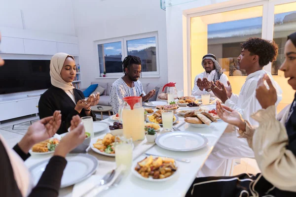 In the sacred month of Ramadan, a diverse Muslim family comes together in spiritual unity, fervently praying to God before breaking their fast, capturing a moment of collective devotion, cultural