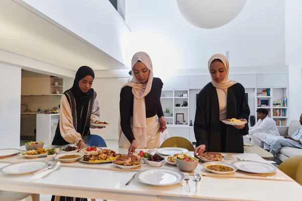 Group of young Arab women come together to lovingly prepare an iftar table during the sacred Muslim month of Ramadan, embodying the essence of communal unity, cultural tradition, and joyous
