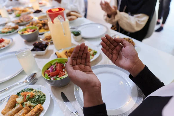 stock image In the sacred month of Ramadan, a diverse Muslim family comes together in spiritual unity, fervently praying to God before breaking their fast, capturing a moment of collective devotion, cultural