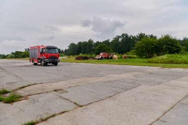 Bu büyüleyici sahnede, gelişmiş kurtarma teknolojisiyle donatılmış gelişmiş bir itfaiye aracı, müdahale etmeye ve hızlı bir şekilde karşılık vermeye hazır olan yetenekli itfaiye ekibiyle birlikte beklemektedir.