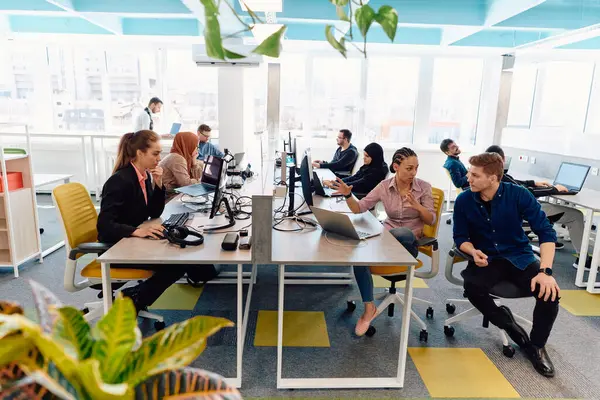 stock image Collaborative process of multicultural skilled young business team during brainstorming meeting in office.Diverse group of young people dressed in formal wear cooperating on developing design project