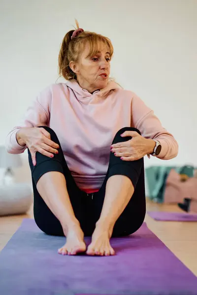 Sunlit Space Senior Woman Gracefully Practices Rejuvenating Yoga Focusing Neck — Stock Photo, Image