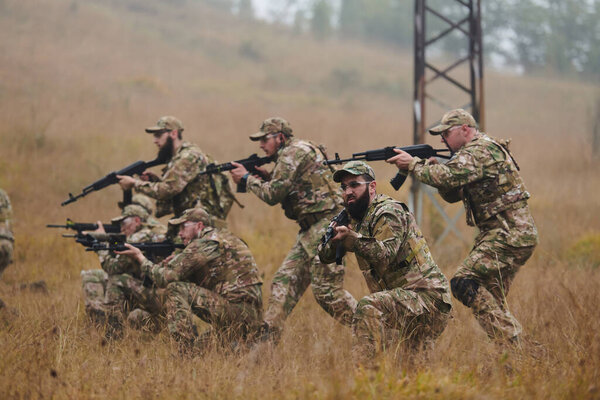 A disciplined and specialized military unit, donned in camouflage, strategically patrolling and maintaining control in a high-stakes environment, showcasing their precision, unity, and readiness for