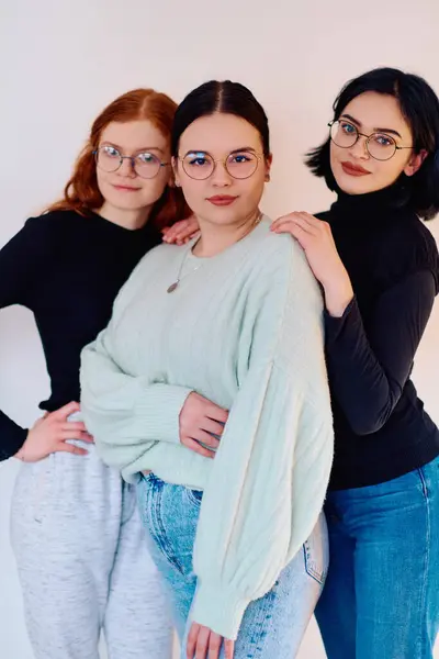 stock image Familial love and unity as three sisters embrace each other against a pure white backdrop, symbolizing the enduring bond of sisterhood. 