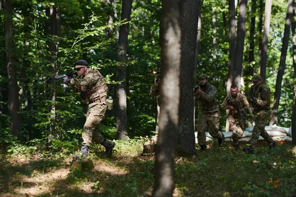 Stock image A specialized military antiterrorist unit conducts a covert operation in dense, hazardous woodland, demonstrating precision, discipline, and strategic readiness. 