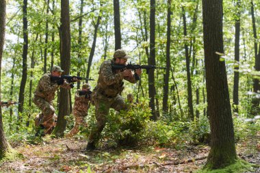 A specialized military antiterrorist unit conducts a covert operation in dense, hazardous woodland, demonstrating precision, discipline, and strategic readiness.  clipart