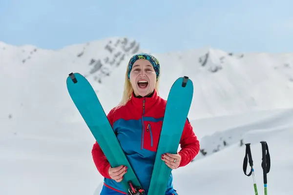 Een Triomfantelijke Vrouwelijke Skiër Balken Met Vertrouwen Bovenop Een Besneeuwde — Stockfoto