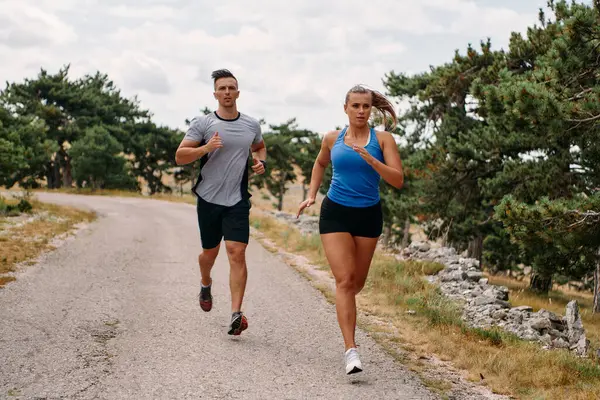 Couple Dressed Sportswear Runs Scenic Road Early Morning Workout Enjoying Royalty Free Stock Images