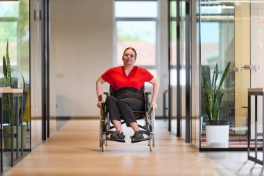 A modern young businesswoman in a wheelchair is surrounded by an inclusive workspace with glass-walled offices, embodying determination and innovation in the business world.  clipart