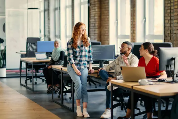 stock image A diverse group of young business individuals congregates in a modern startup coworking center, embodying collaborative innovation and a dynamic atmosphere.
