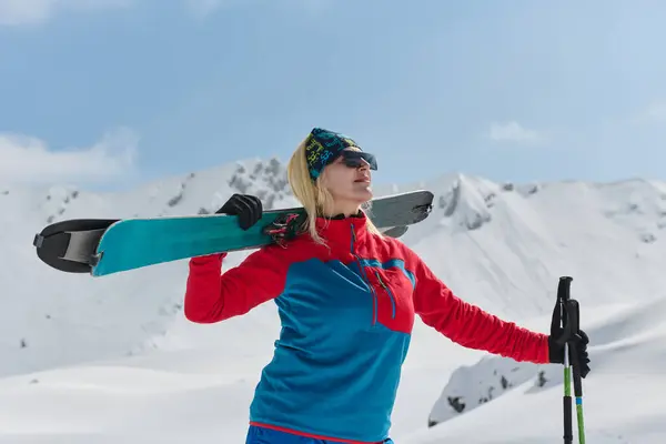 stock image A professional woman skier rejoices after successfully climbing the snowy peaks of the Alps.