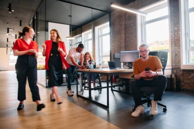 Çeşitli meslek grupları, cep telefonları ve bilgisayarlar gibi kağıt bazlı ve teknolojik araçların bir karışımını kullanarak, modern bir ortak çalışma merkezinde iş birliği yapmaktadır. .