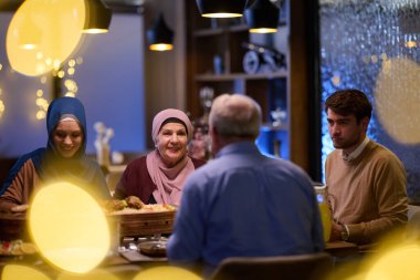 A modern and traditional European Islamic family comes together for iftar in a contemporary restaurant during the Ramadan fasting period, embodying cultural harmony and familial unity amidst a clipart
