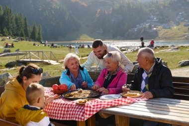 A family on a mountain vacation indulges in the pleasures of a healthy life, savoring traditional pie while surrounded by the breathtaking beauty of nature, fostering family bonds and embracing the clipart