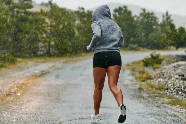 Stock image Rain or shine, a dedicated marathoner powers through her training run, her eyes set on the finish line. 