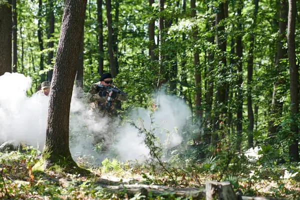 Stock image A specialized military antiterrorist unit conducts a covert operation in dense, hazardous woodland, demonstrating precision, discipline, and strategic readiness. 