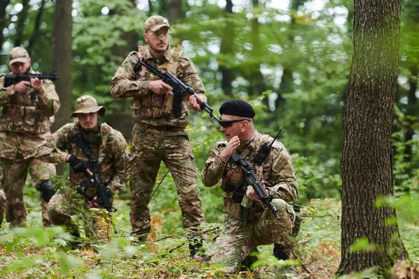 Stock image A disciplined and specialized military unit, donned in camouflage, strategically patrolling and maintaining control in a high-stakes environment, showcasing their precision, unity, and readiness for