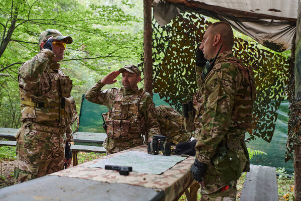 A highly trained military unit strategizes and organizes a tactical mission while studying a military map during a briefing session. 