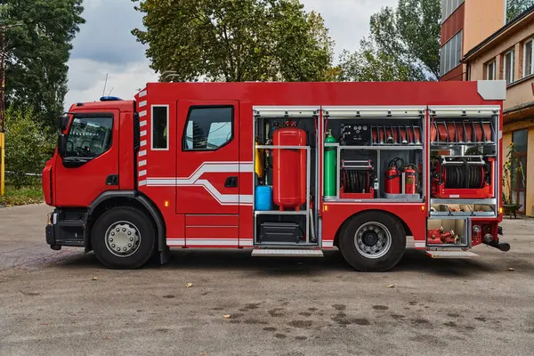 stock image A state-of-the-art firetruck, equipped with advanced rescue technology, stands ready with its skilled firefighting team, prepared to intervene and respond rapidly to emergencies, ensuring the safety