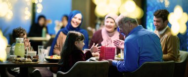 Büyükbabalar, kutsal Ramazan ayında iftar için bir restoranda toplanan çocuklarına ve torunlarına hediyeler getirip sevgi, birlik ve sevgi dolu anlarını paylaşıyorlar.