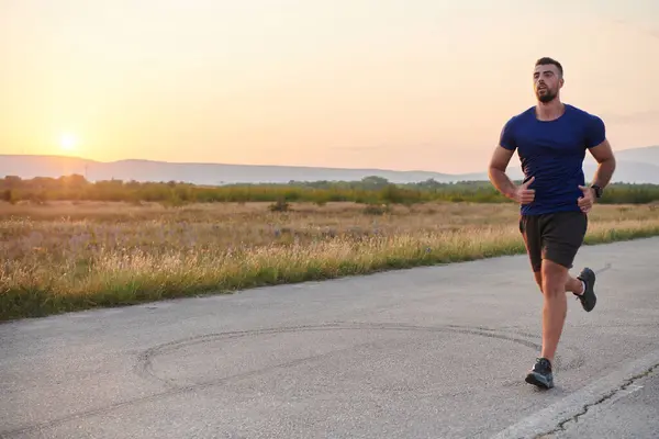 stock image A highly motivated marathon runner displays unwavering determination as he trains relentlessly for his upcoming race, fueled by his burning desire to achieve his goals. 