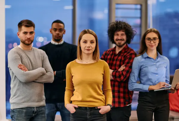 Stock image Portrait of successful creative business team looking at camera and smiling. Diverse business people standing together at startup. 