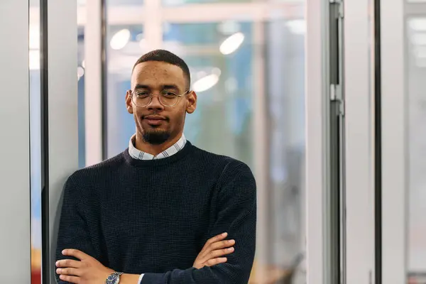 stock image  African American man looking at camera standing in office lobby hall. Multicultural company managers team portrait. High quality photo