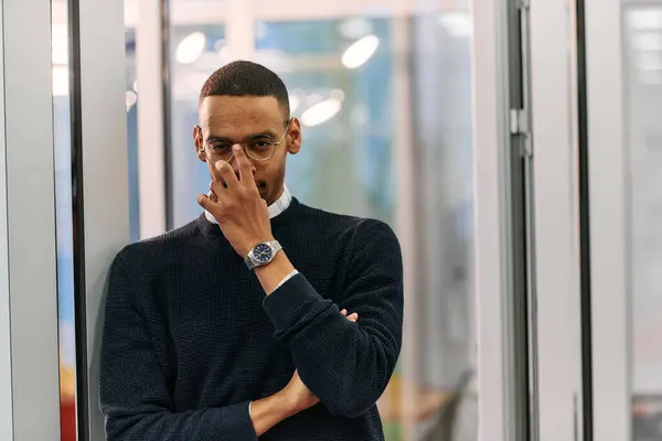 stock image  African American man looking at camera standing in office lobby hall. Multicultural company managers team portrait. High quality photo