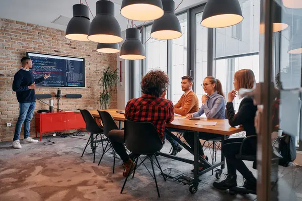 stock image In a corporate setting, an African-American businessman leads a meeting, passionately presenting a business plan to his attentive team, fostering collaboration and strategic thinking. 