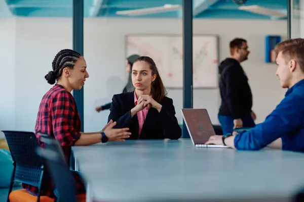 stock image A team of successful programmers sits in a startup office, strategizing new business projects and solving existing challenges, showcasing innovation and collaboration in the tech industry. 