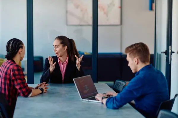 stock image A team of successful programmers sits in a startup office, strategizing new business projects and solving existing challenges, showcasing innovation and collaboration in the tech industry. 