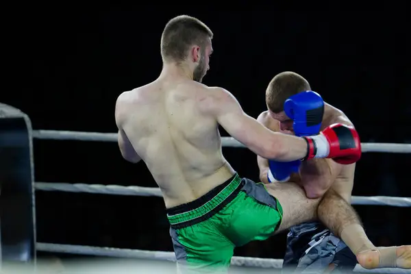 stock image Two skilled kickboxers engage in a fierce and technical exchange of kicks in a captivating display of athleticism and combat prowess. 