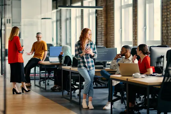 stock image A diverse group of young business individuals congregates in a modern startup coworking center, embodying collaborative innovation and a dynamic atmosphere.