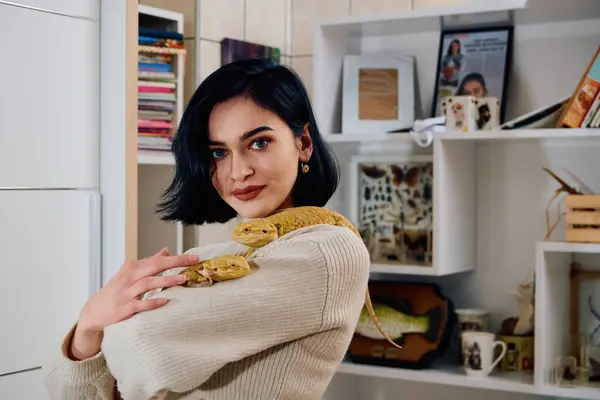 stock image A beautiful woman in a joyful moment, posing with her two adorable bearded dragon pets, radiating love and companionship.