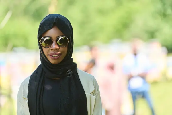 stock image African American Muslim woman in hijab explores natural bee farms for honey production, blending tradition with sustainability in the serene countryside. 