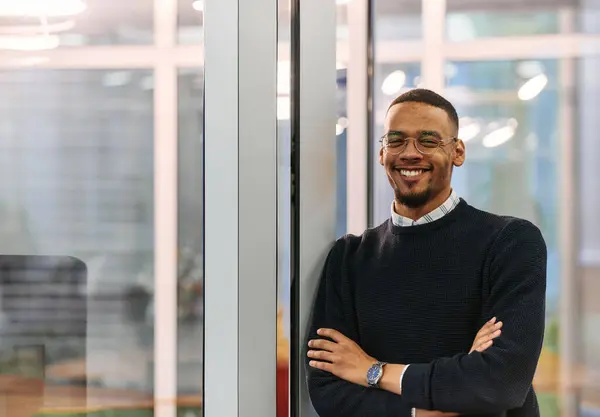 stock image  African American man looking at camera standing in office lobby hall. Multicultural company managers team portrait. High quality photo