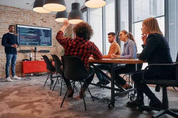 stock image In a corporate setting, an African-American businessman leads a meeting, passionately presenting a business plan to his attentive team, fostering collaboration and strategic thinking. 