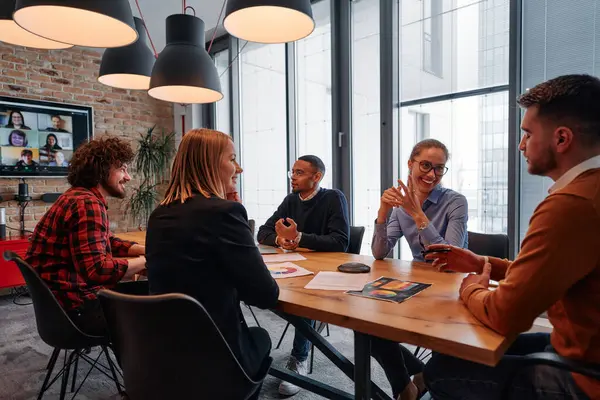 stock image A diverse team of business professionals engage in discussions on various projects and develop new business strategies, epitomizing creativity and innovation in the entrepreneurial landscape. 