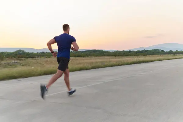 stock image A highly motivated marathon runner displays unwavering determination as he trains relentlessly for his upcoming race, fueled by his burning desire to achieve his goals. 