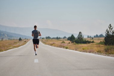 A highly motivated marathon runner displays unwavering determination as he trains relentlessly for his upcoming race, fueled by his burning desire to achieve his goals.  clipart