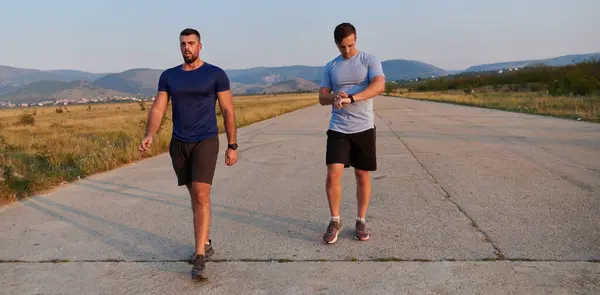 stock image In anticipation of an upcoming marathon competition, two athletic friends train side by side, embodying the spirit of teamwork, dedication, and mutual support in their shared fitness journey.