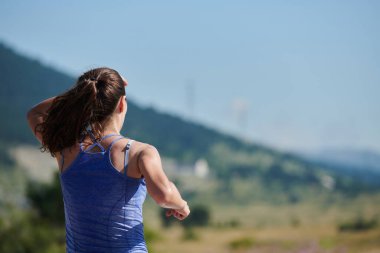 An athletic woman finds freedom and joy in a healthy lifestyle, running through a beautiful road trail at sunrise.  clipart