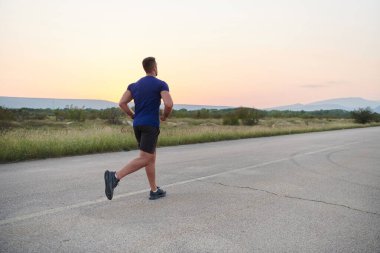 A highly motivated marathon runner displays unwavering determination as he trains relentlessly for his upcoming race, fueled by his burning desire to achieve his goals.  clipart