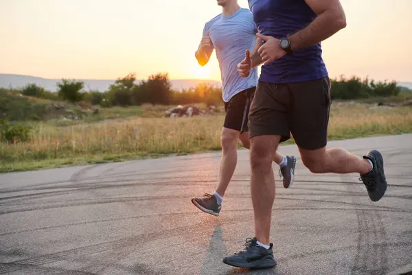 stock image In anticipation of an upcoming marathon competition, two athletic friends train side by side, embodying the spirit of teamwork, dedication, and mutual support in their shared fitness journey.