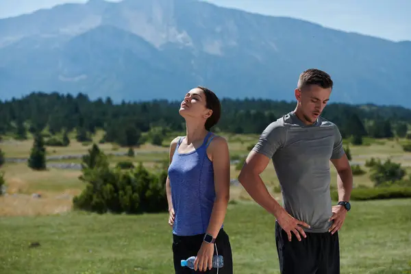 stock image In a serene moment of post-run tranquility, a romantic couple rests together, embodying both exhaustion and affection after a rigorous training session.