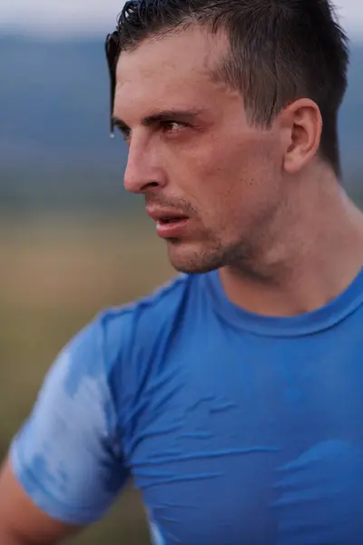 stock image After completing a grueling daily run, a sweaty athlete takes a well-deserved rest, showcasing the physical exertion and dedication of their training regimen.